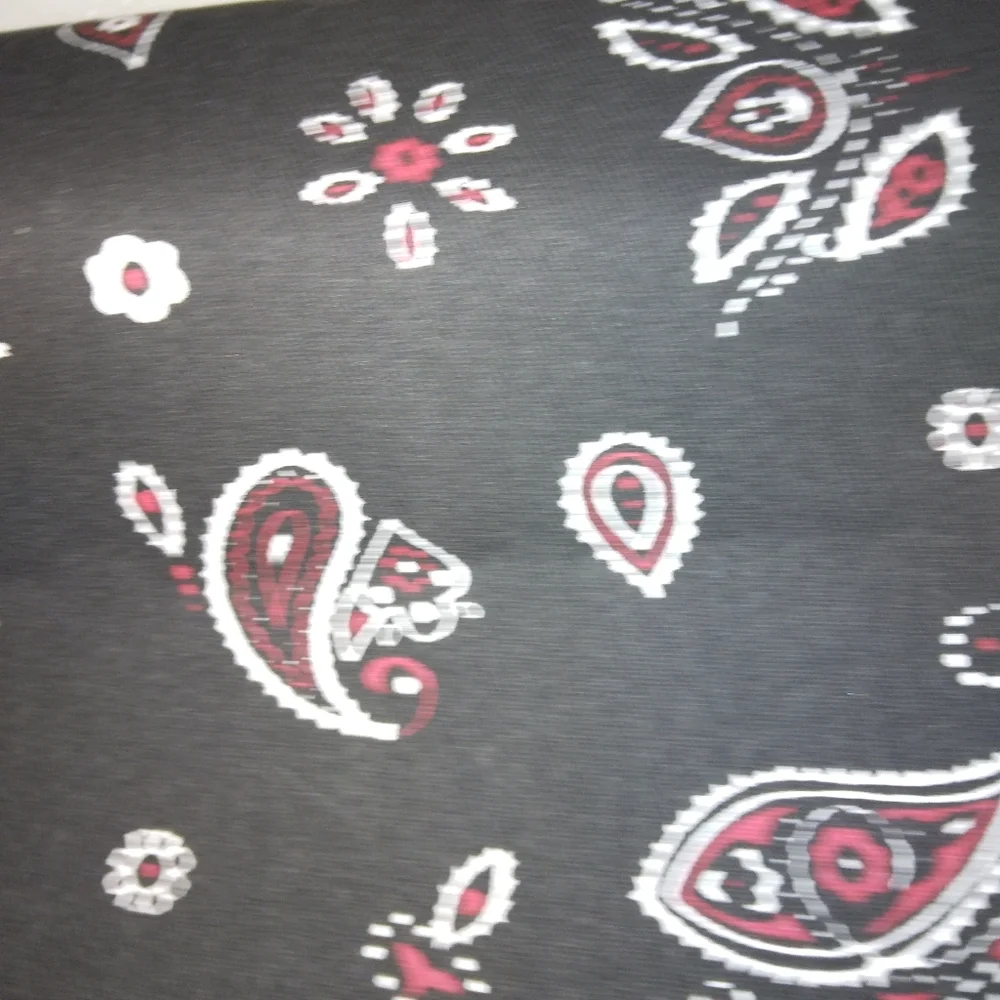 FABRIC Red and white paisley print on black background, twill weave